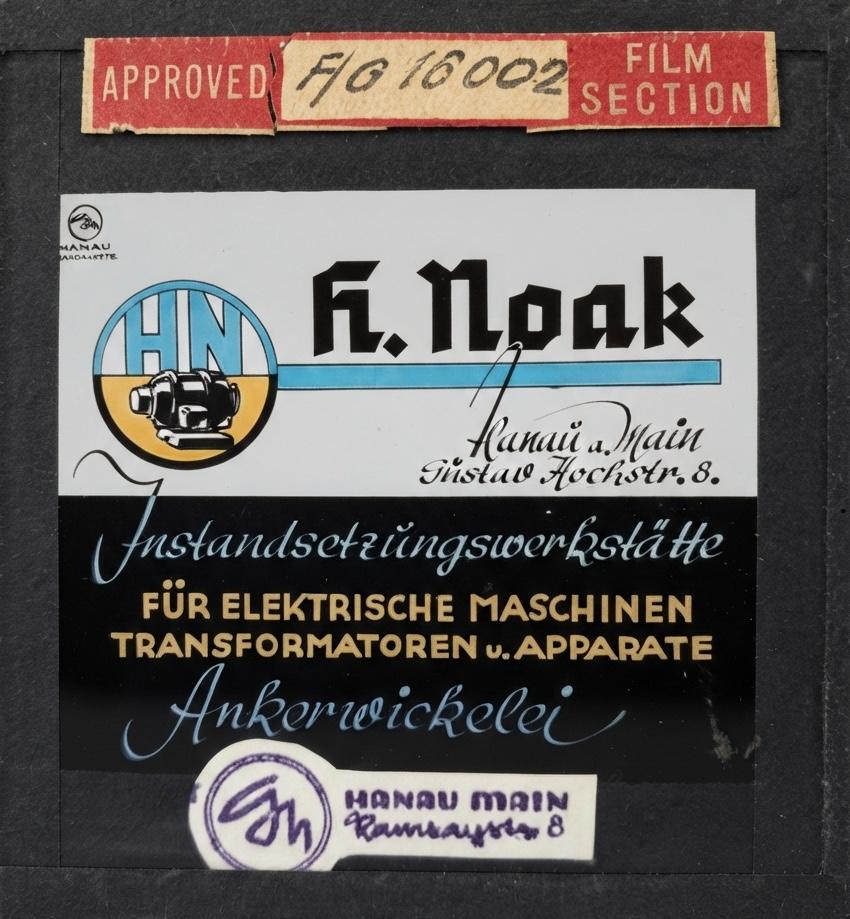 Kinodia „H. Noak, Hanau a. Main, Gustav-Hoch-Str. 8: Instandsetzungswerkstätte für elektrische Maschinen, Transformatoren und Apparate, Ankerwickelei“ mit Zulassungsetikett